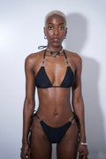 Rosemary Bikini Top Black on model featuring halter neck design and double silver rings hardware.